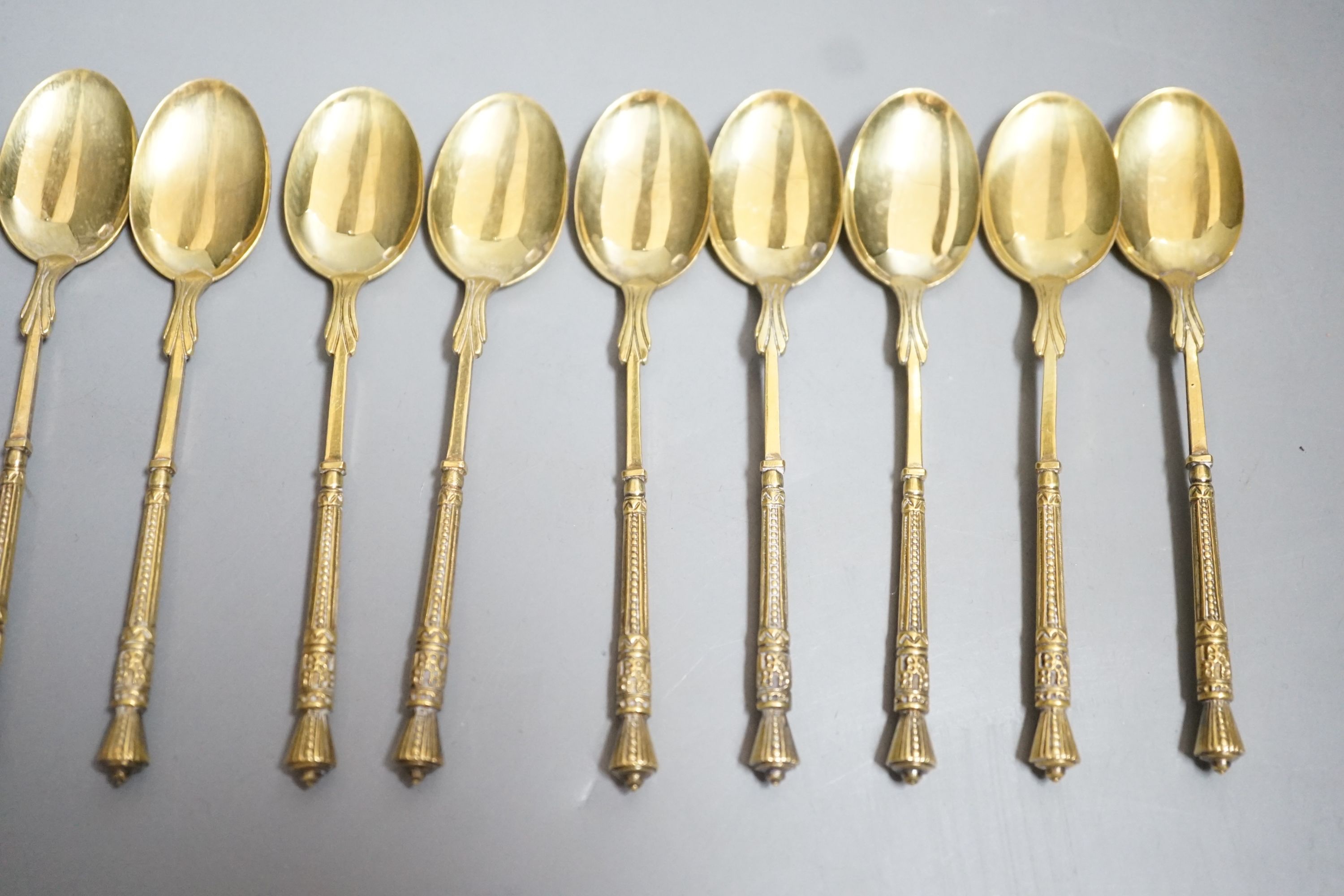 A set of twelve French 950 standard gilt white metal coffee spoons, 11cm, 5.2oz.